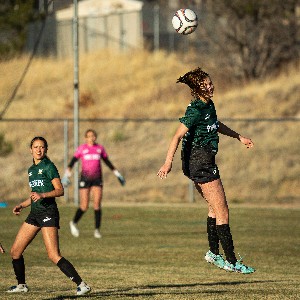 JV Girls Soccer player hits a header